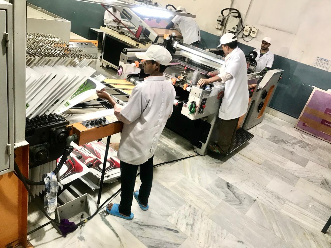 Automatic screen printing line producing OEM decals at Ripu Daman Graphics, Delhi